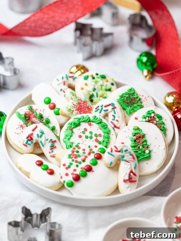 Authentic Japanese Strawberry Shortcake Recipe — Light, Fluffy Layers 17 Christmas cut out cookies on a plate with sprinkles and royal icing decoration next to cookie cutters, ornaments, and red ribbon