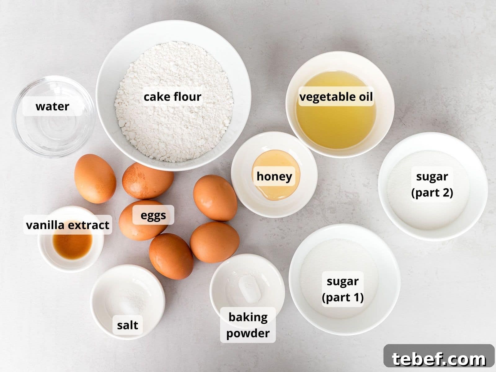 Authentic Japanese Strawberry Shortcake Recipe — Light, Fluffy Layers 6 labeled photo of ingredients for Japanese strawberry shortcake in white bowls that includes eggs, cake flour, and sugar
