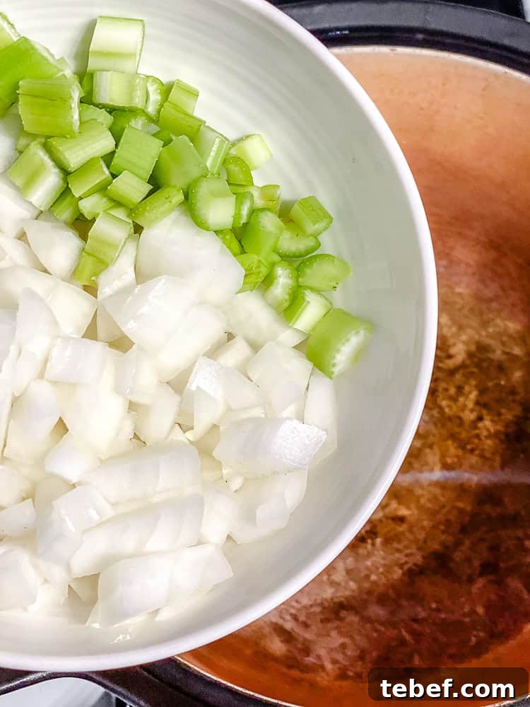 process shot showing veggies being added to pan
