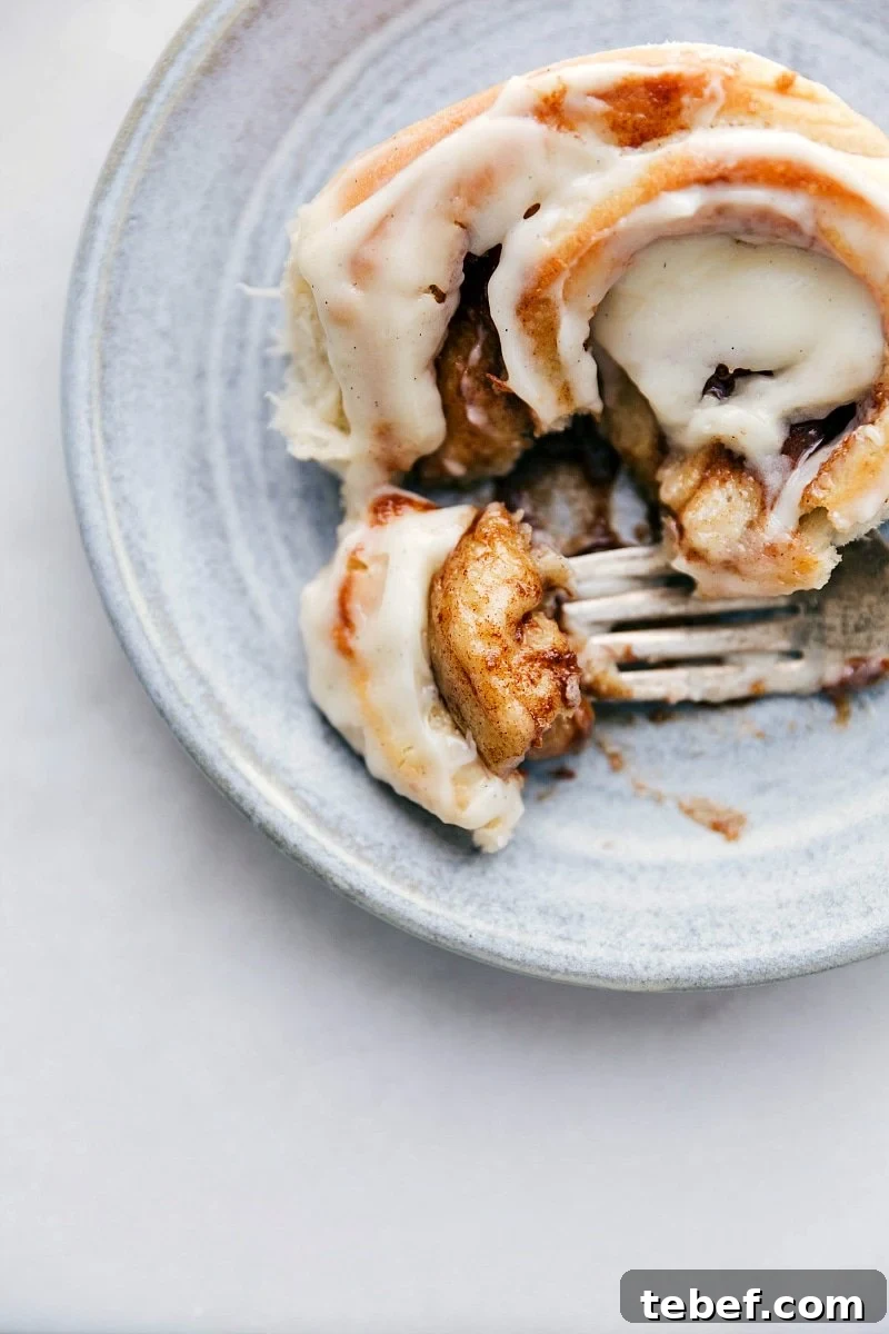 Homemade Cinnamon Roll with bite taken out of it.