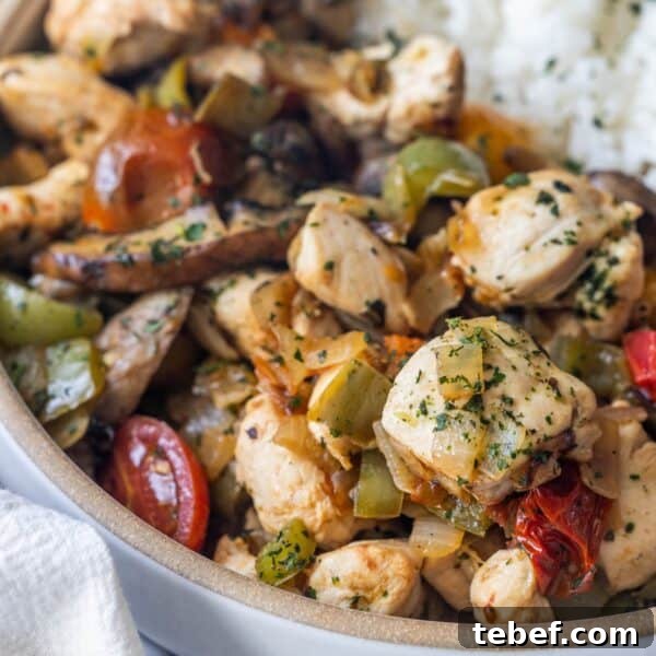 Garlic Butter Shrimp Scampi Recipe for Quick Weeknight Meals 14 A close-up of a bowl filled with cooked chicken pieces, bell peppers, tomatoes, and herbs