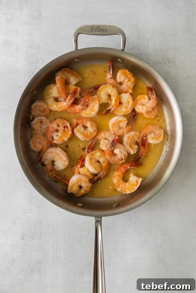 Garlic Butter Shrimp Scampi Recipe for Quick Weeknight Meals 7 shrimp in a scampi butter sauce in a large pan