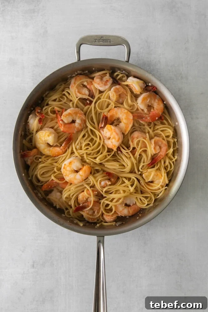 Garlic Butter Shrimp Scampi Recipe for Quick Weeknight Meals 8 shrimp and pasta in a pan in butter and wine sauce