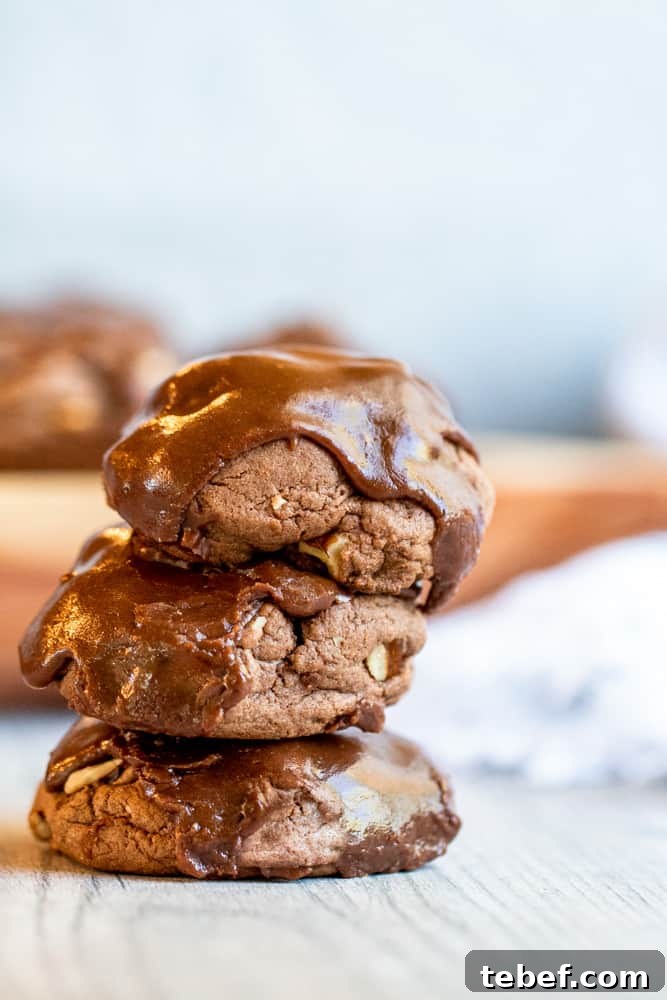 Stack of three cookies on a white counter.