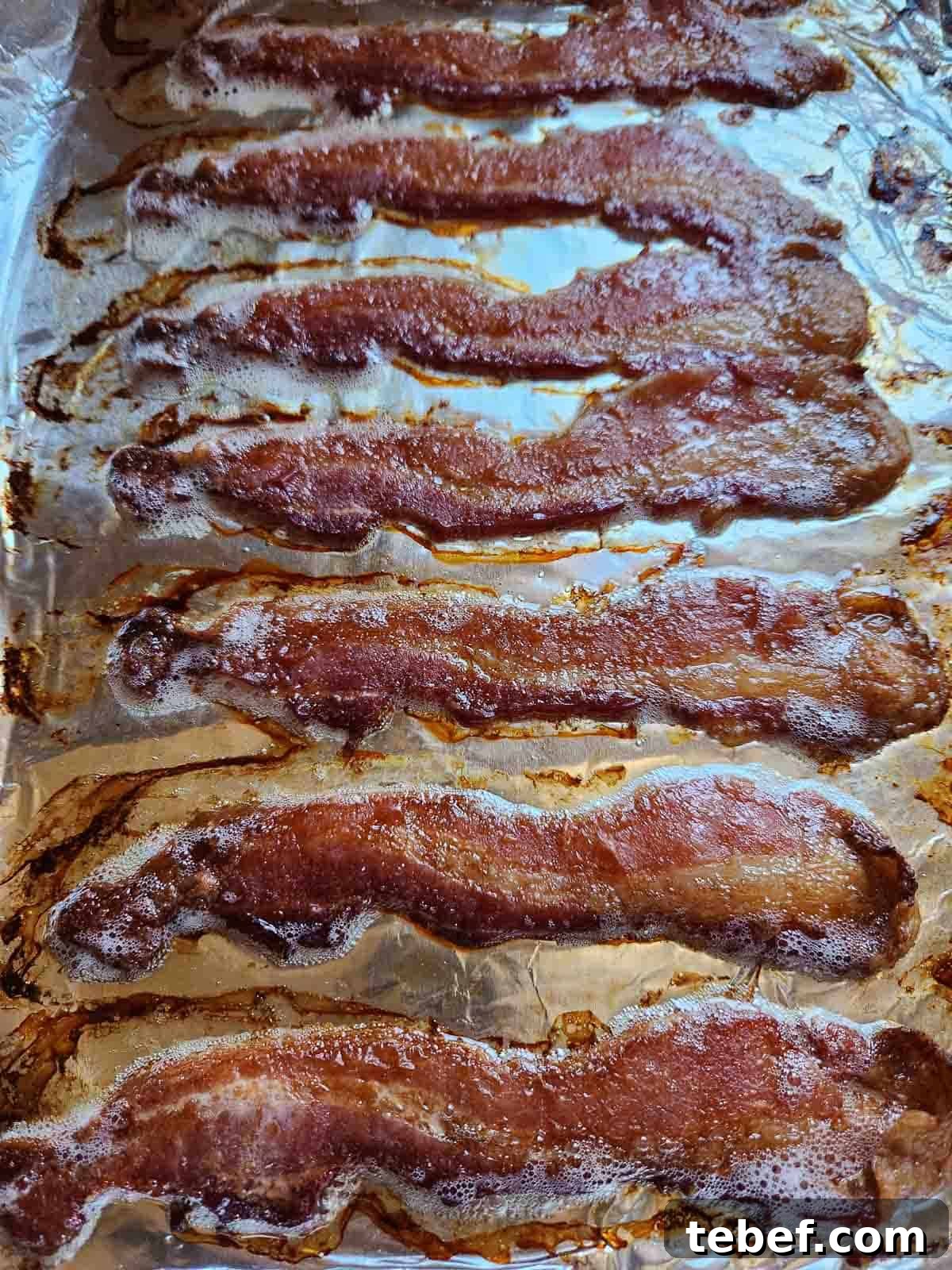 Buttermilk Bacon and Egg Bites Recipe for Brunch or Meal Prep 4 Cooked bacon on a sheet pan.