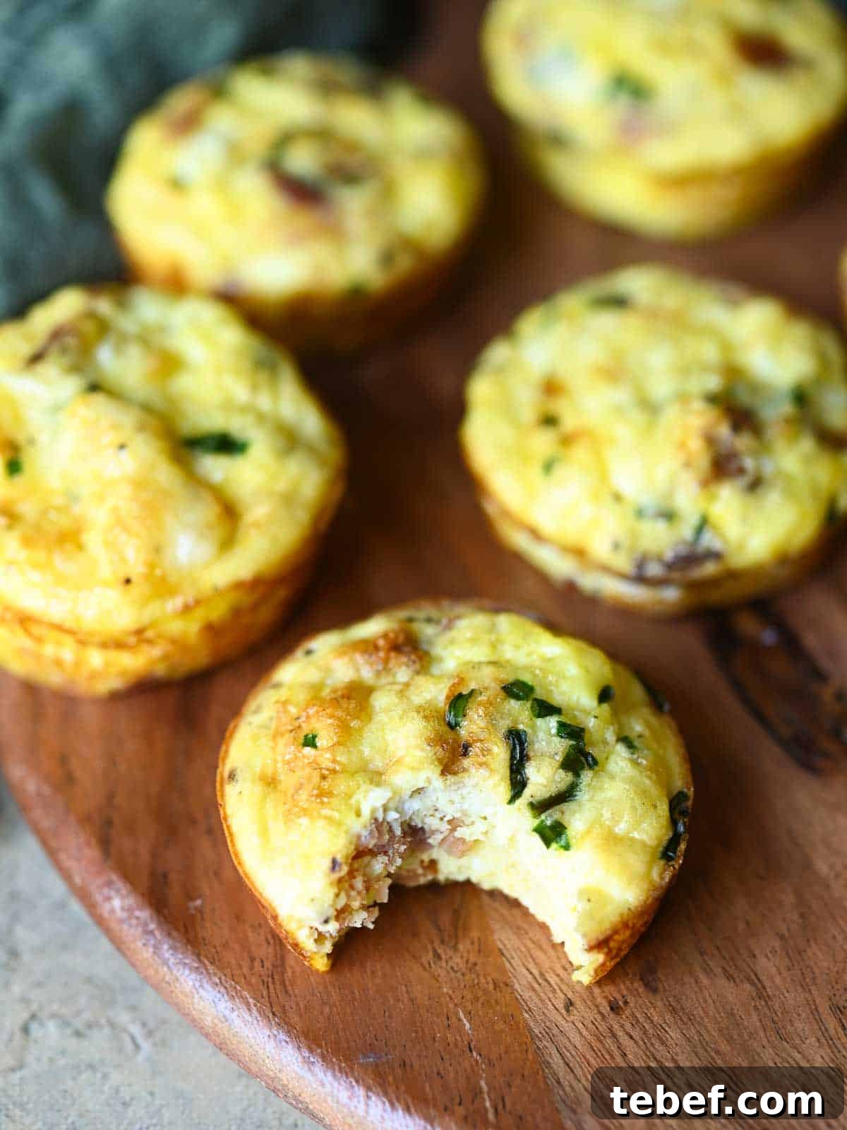 Buttermilk Bacon and Egg Bites Recipe for Brunch or Meal Prep 9 Close-up of an egg bite with a bite taken.