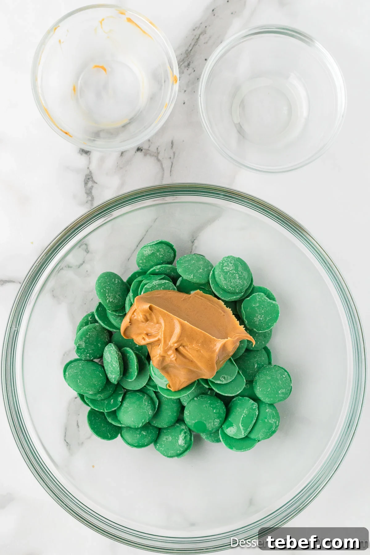 Grinch Puppy Chow Holiday Snack Mix Recipe 4 Mixing bowl with peanut butter and candy melts.