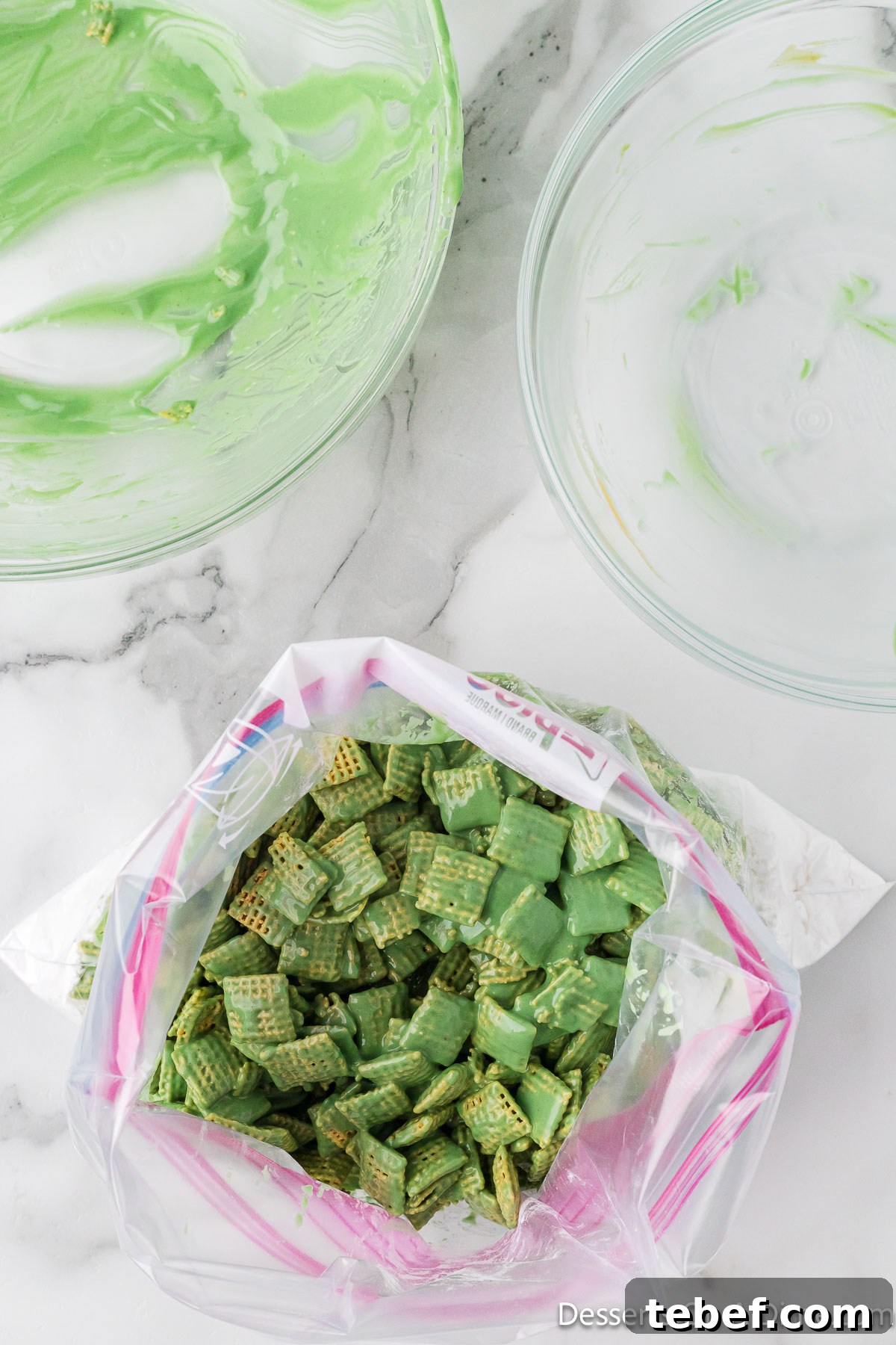Grinch Puppy Chow Holiday Snack Mix Recipe 7 Coated cereal in a ziplock bag.