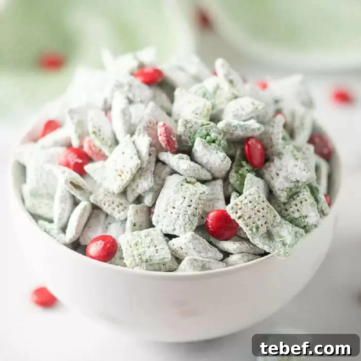 Grinch Puppy Chow Holiday Snack Mix Recipe 10 Grinch Puppy chow in a bowl.