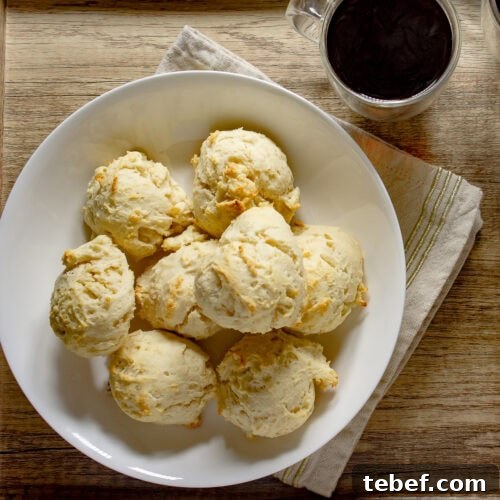 Flaky No-Knead Drop Biscuits Recipe for Quick Homemade Baking 7 a white bowl of baked no-knead biscuits.