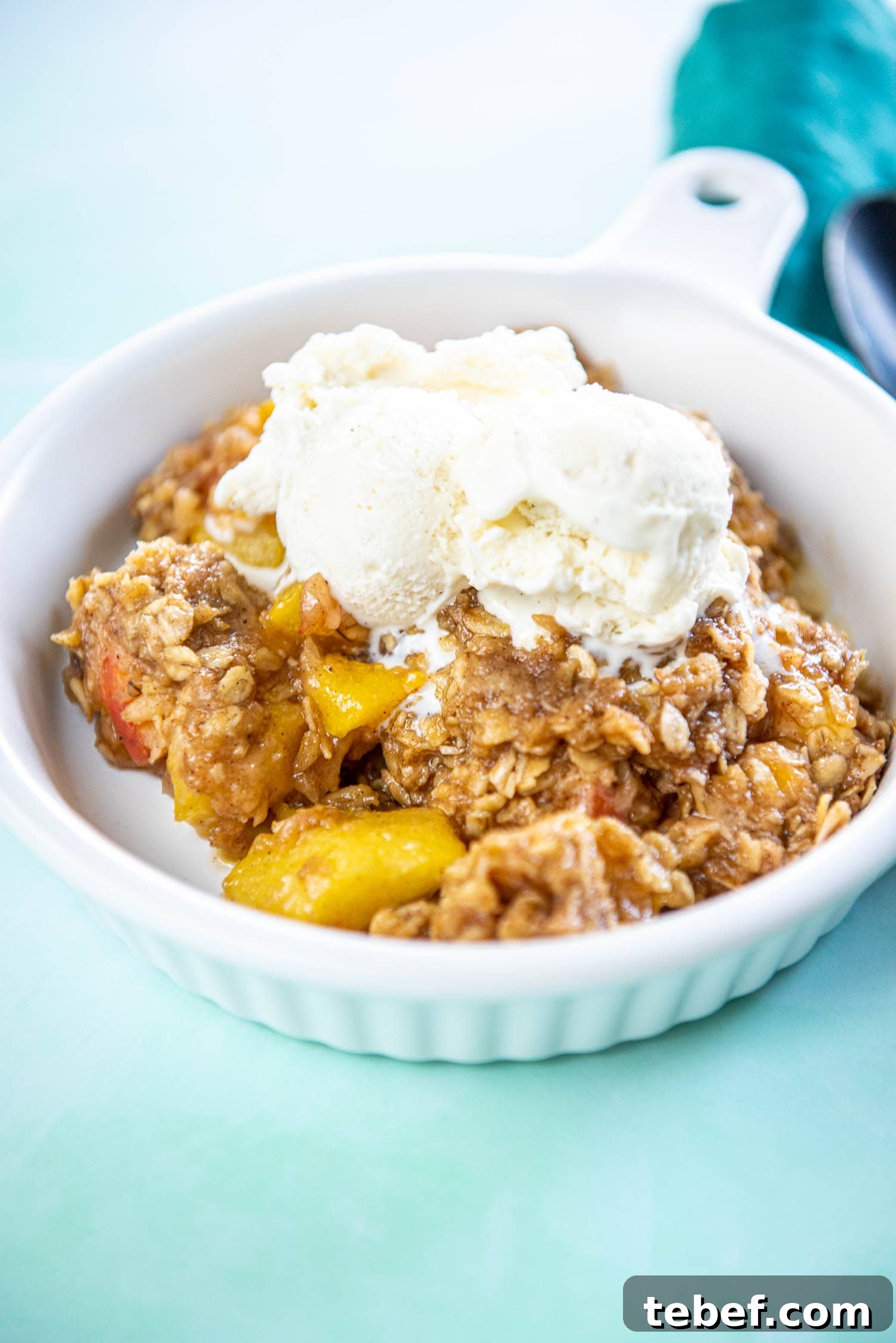 Slow Cooker Fresh Peach Cobbler Recipe with Homemade Topping 2 white ramekin with peach cobbler topped with ice cream