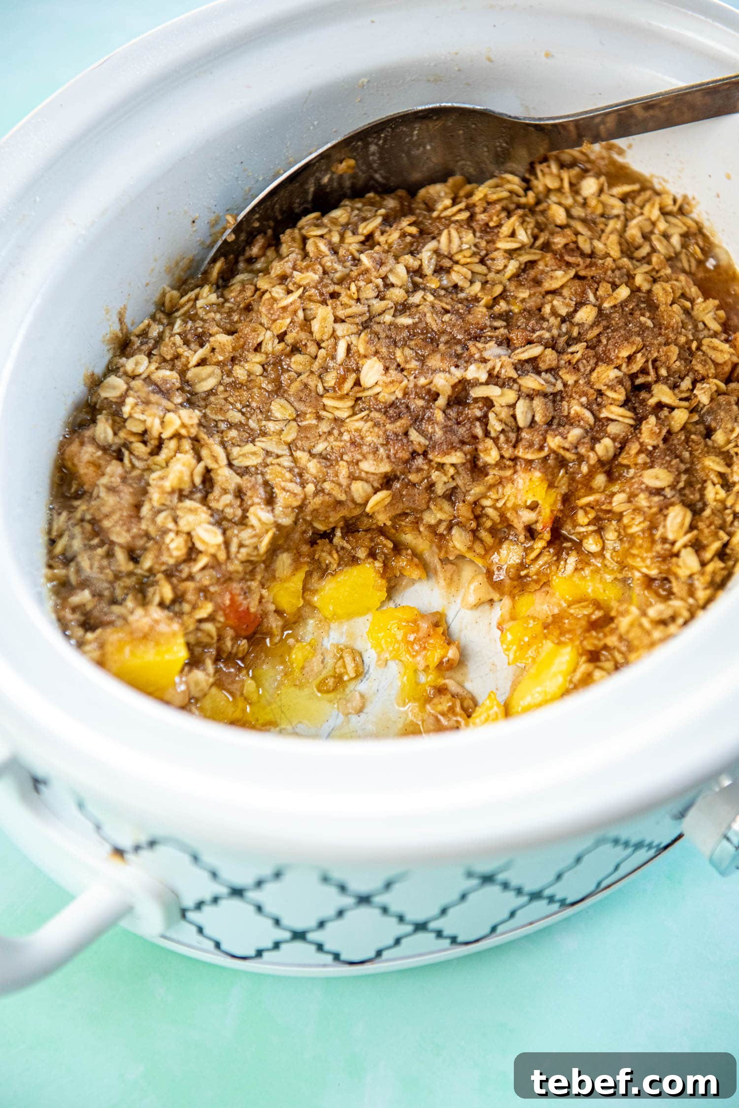Slow Cooker Fresh Peach Cobbler Recipe with Homemade Topping 4 slow cooker with peach cobbler scooped out