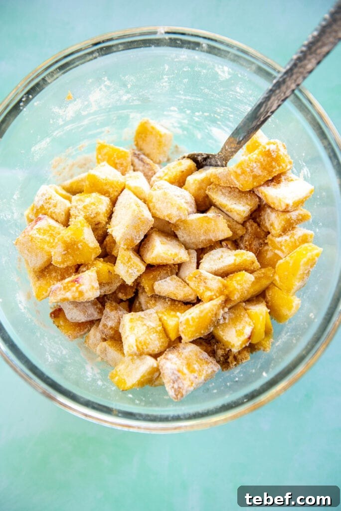 Slow Cooker Fresh Peach Cobbler Recipe with Homemade Topping 7 glass bowl with chopped peaches mixed with flour