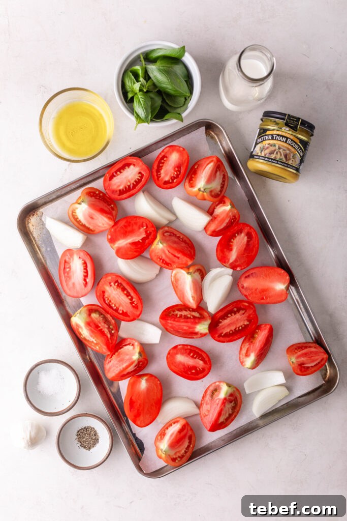 Creamy Sheet-Pan Roasted Tomato Soup Recipe 4 creamy roasted tomato soup ingredients. pan with sliced tomatoes and onions, cooking oil, fresh basil, heavy cream, chicken bouillon, salt, pepper, and garlic cloves