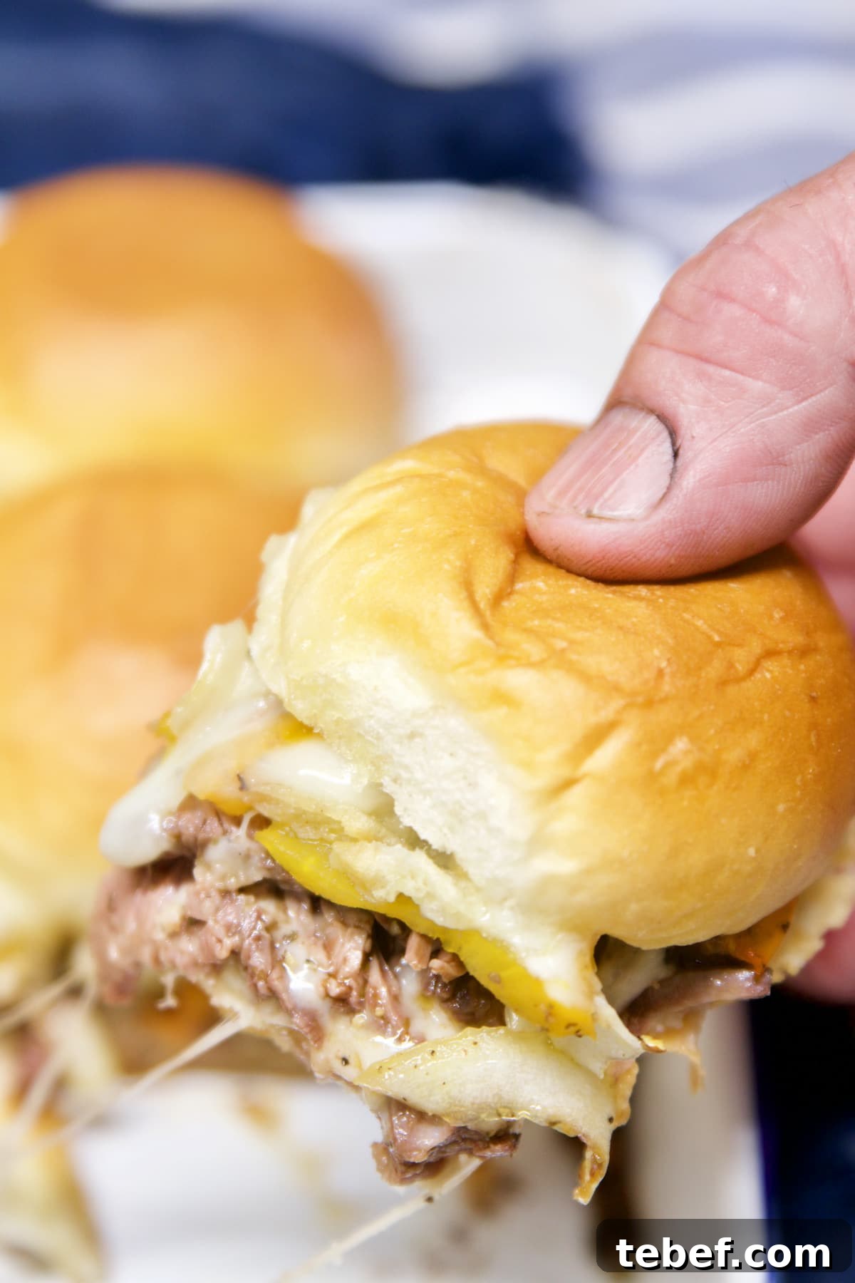 Grilled Philly Cheesesteak Sliders - held in hand.