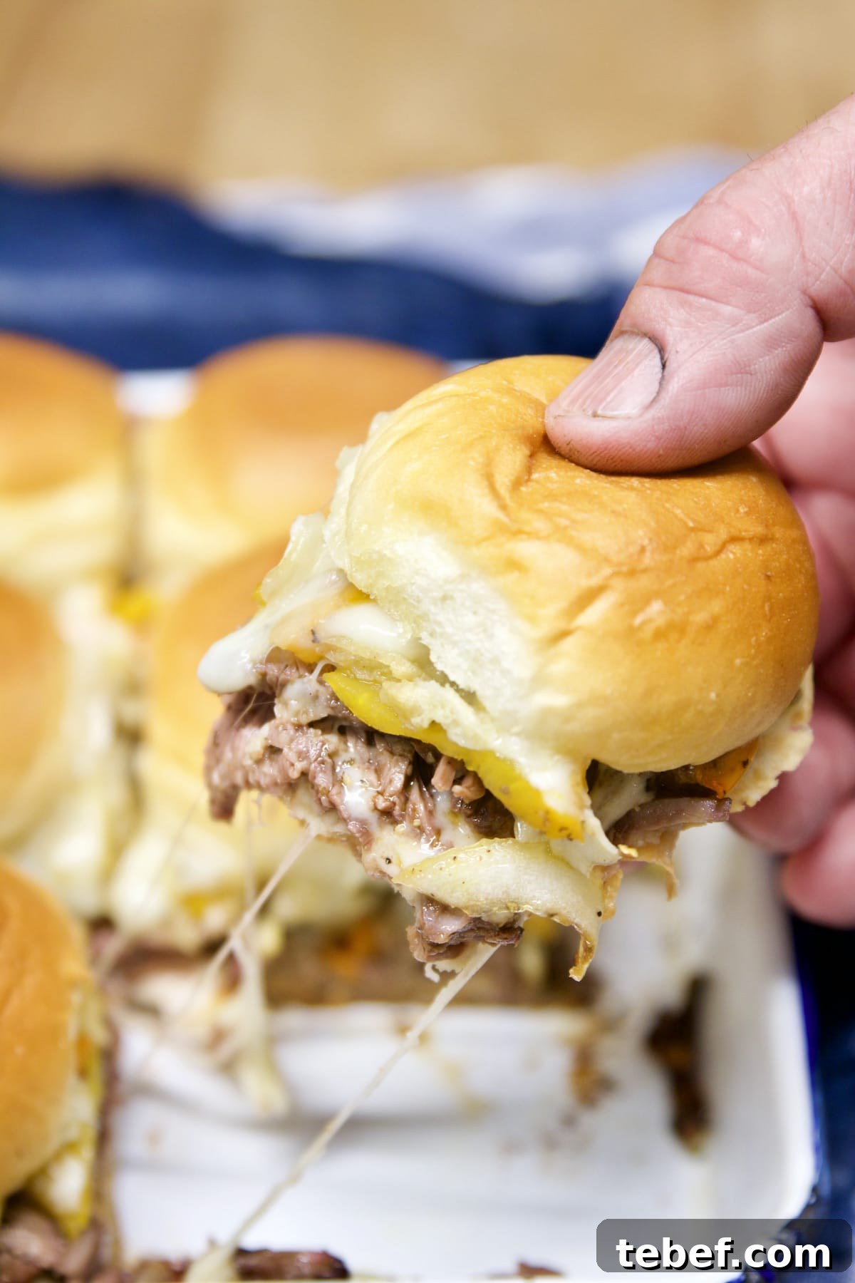 Pulling slider sandwich from the pan.