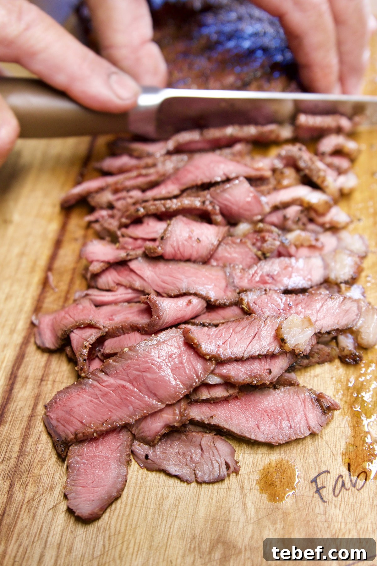 Slicing sirloin steak.