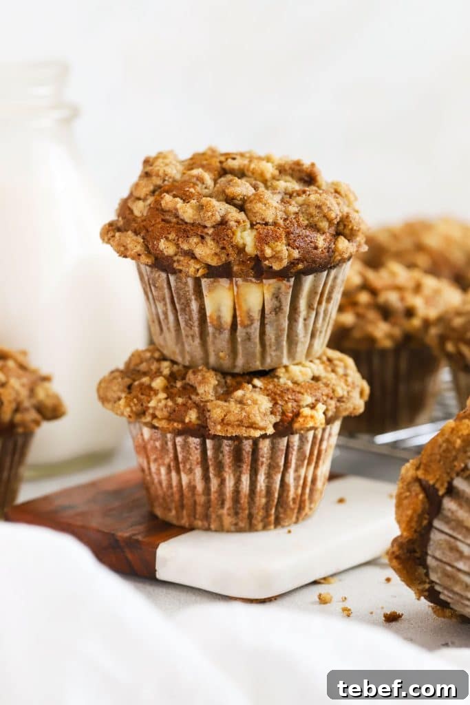 Gluten-Free Blueberry Muffins Recipe with Tender, Moist Texture 10 Two pumpkin cream cheese muffins stacked next to a bottle of milk