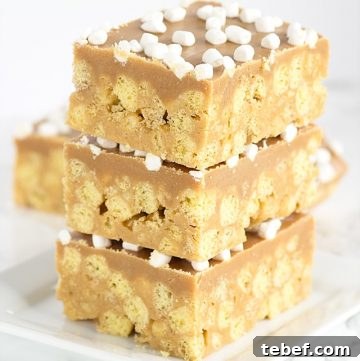 No Bake Peanut Butter Cereal Bars stacked on a plate.