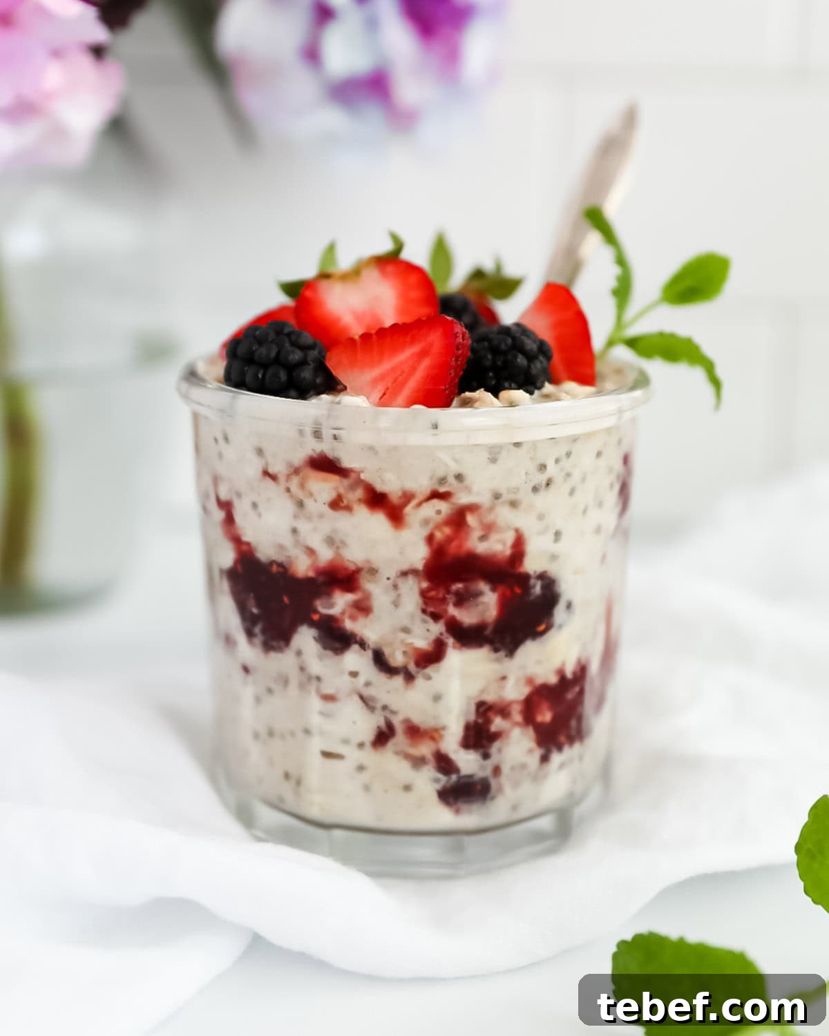 Peanut Butter and Jelly Overnight Oats Recipe for a Quick Breakfast 2 Overnight oats with jelly and fruit in a jar.