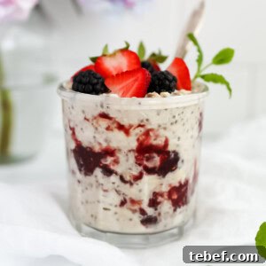 Peanut Butter and Jelly Overnight Oats Recipe for a Quick Breakfast 10 Peanut butter overnight oats in a jar with fresh fruit and a spoon.