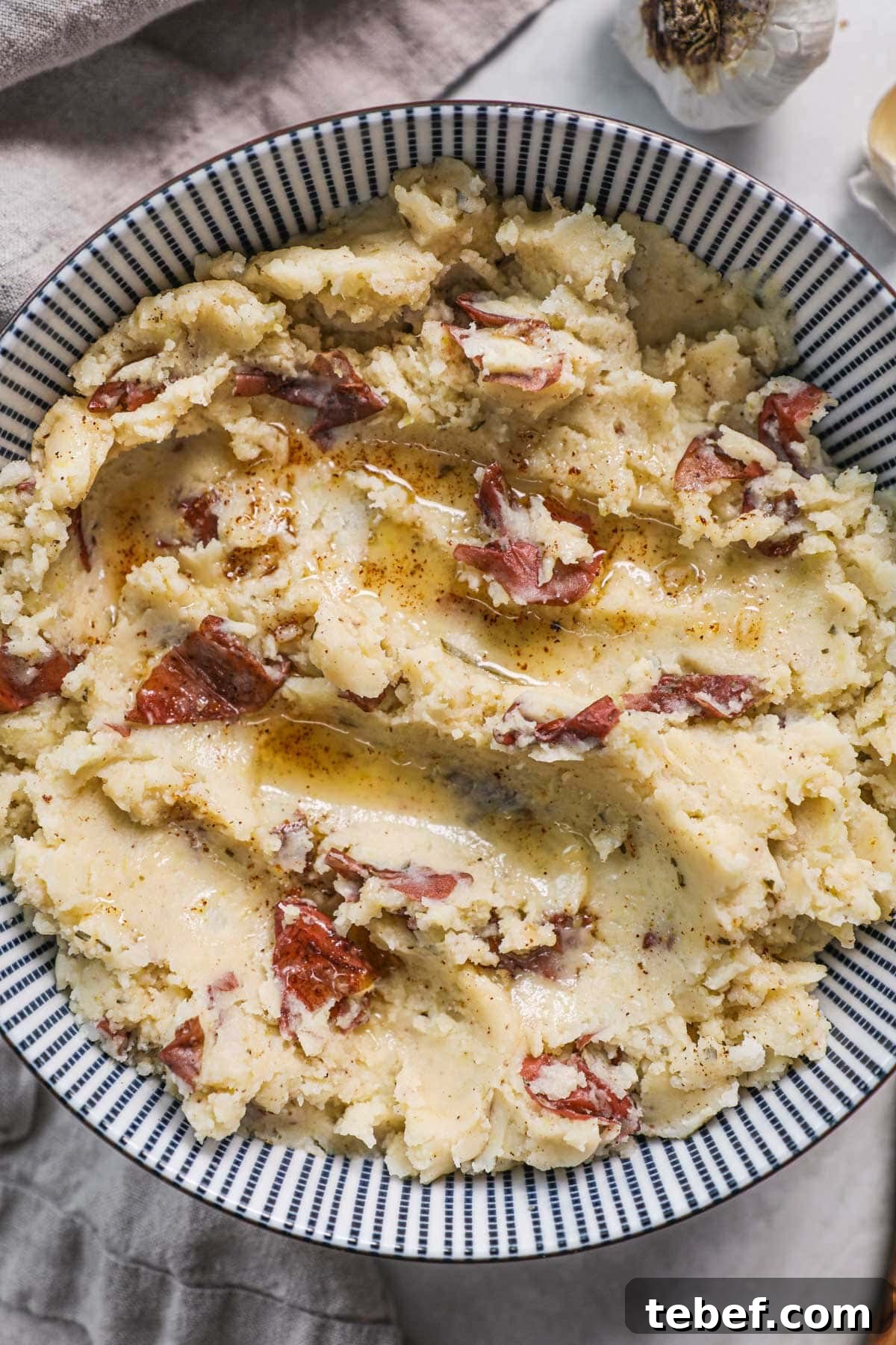Stress-Free Thanksgiving Hosting: Planning Tips for a Smooth Holiday 5 Mashed potatoes with red skin topped with a drizzle of browned butter.