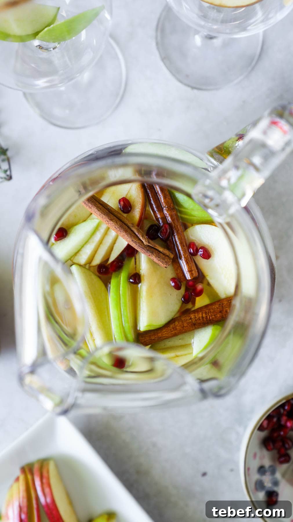 Stress-Free Thanksgiving Hosting: Planning Tips for a Smooth Holiday 7 Pitcher of fall sangria with apples, cinnamon sticks, pomegranate, white wine, and pumpkin spice.