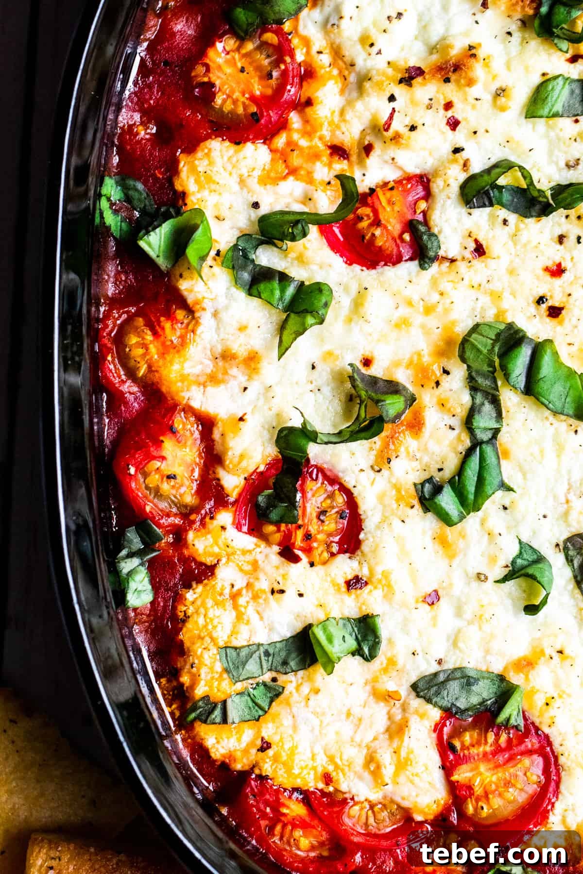 Baked Goat Cheese Dip with Marinara: Creamy Oven-Baked Recipe 2 Overhead shot of goat cheese dip in black baking dish.