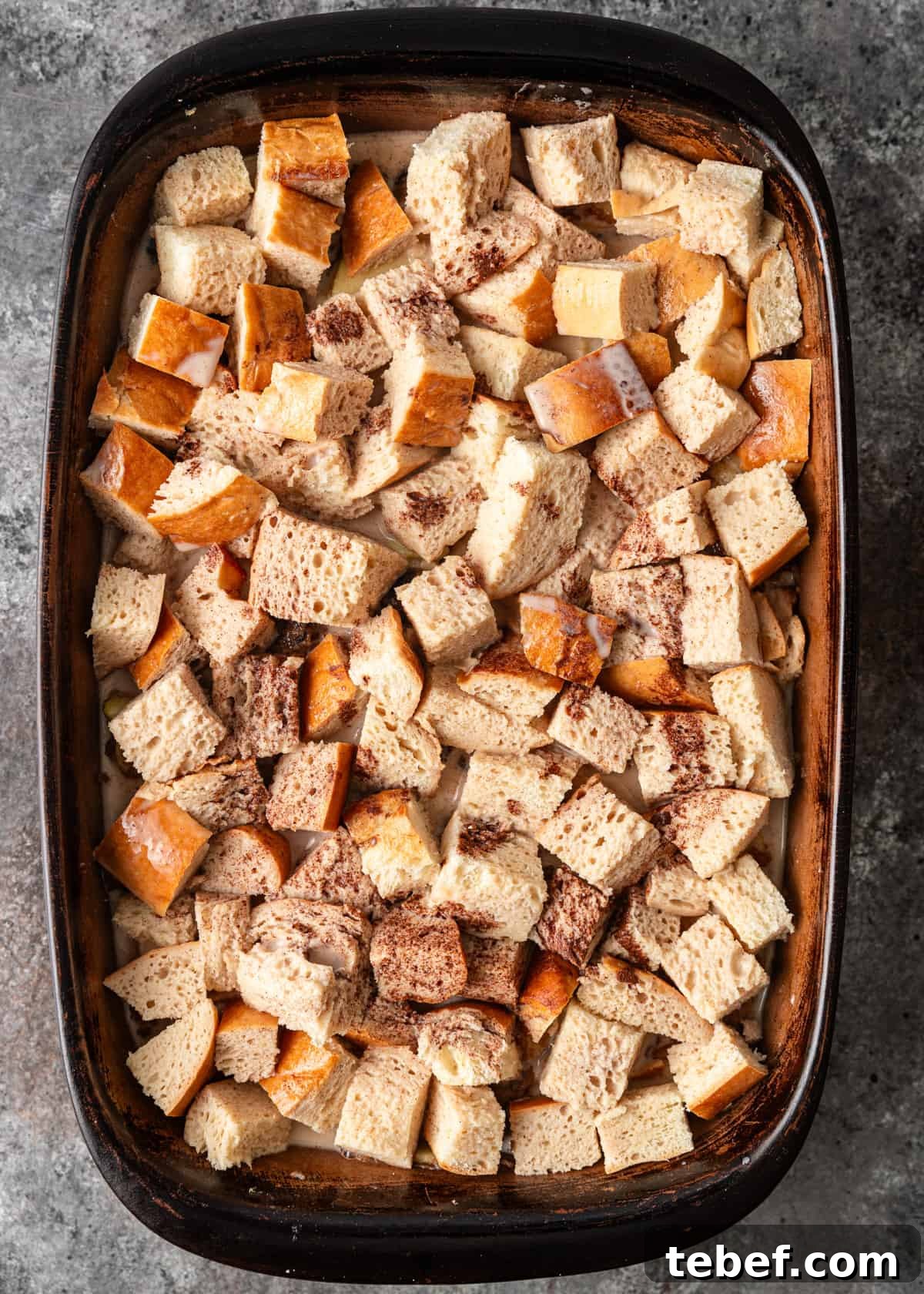 Mom’s Overnight French Toast Casserole Recipe for Busy Mornings 8 overhead: French toast casserole recipe assembled in a baking dish after adding bread and the egg mixture