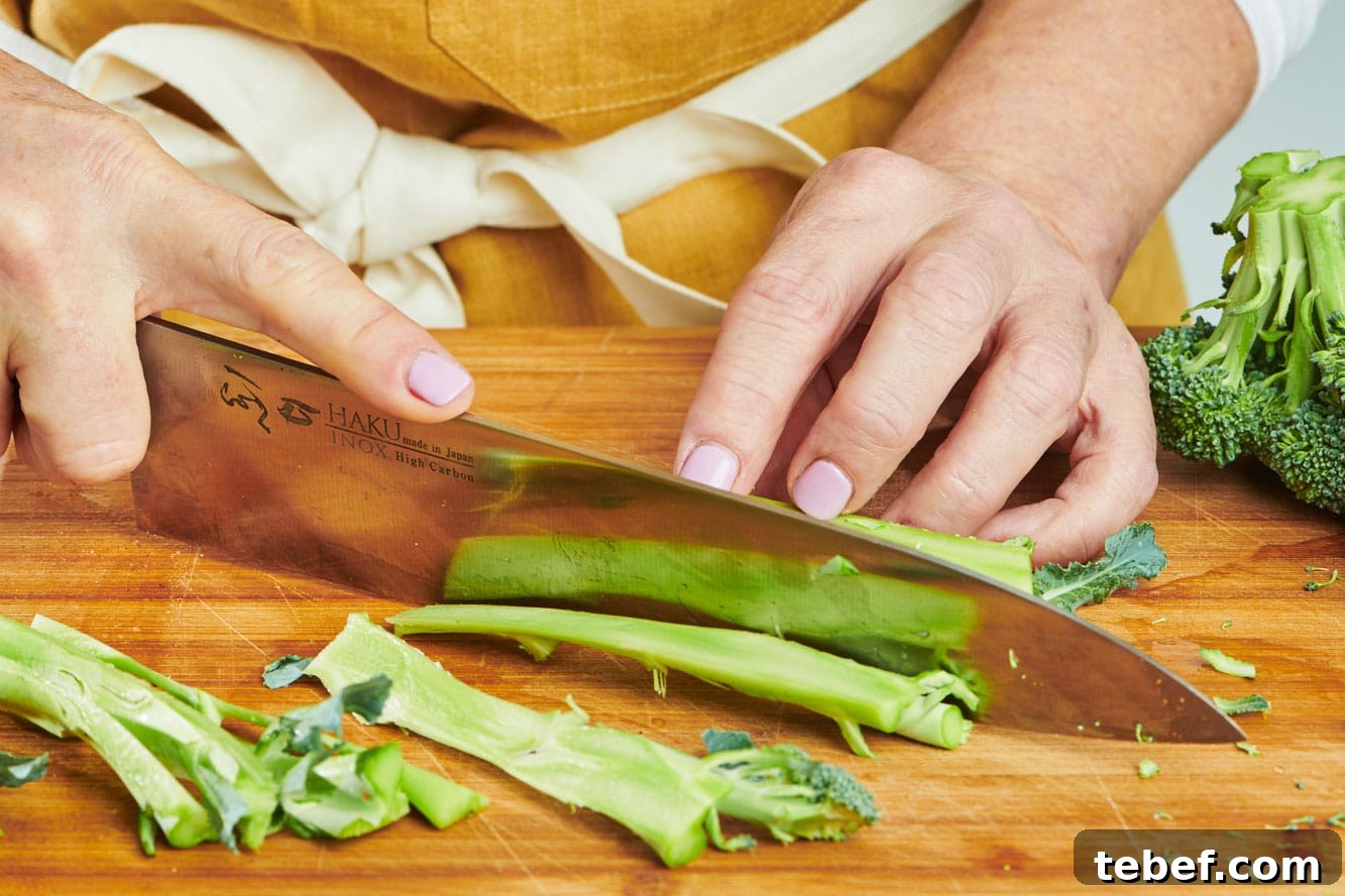How to Trim, Chop, and Cook Broccoli for Perfect Results 5 Trimming broccoli peel with knife.