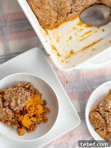 a piece of pumpkin dump cake in a bowl next to the pan
