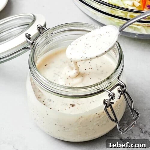 14 Flavorful Salad Dressings and Vinaigrettes for Fresh Salads 12 A container with coleslaw dressing and a spoon.