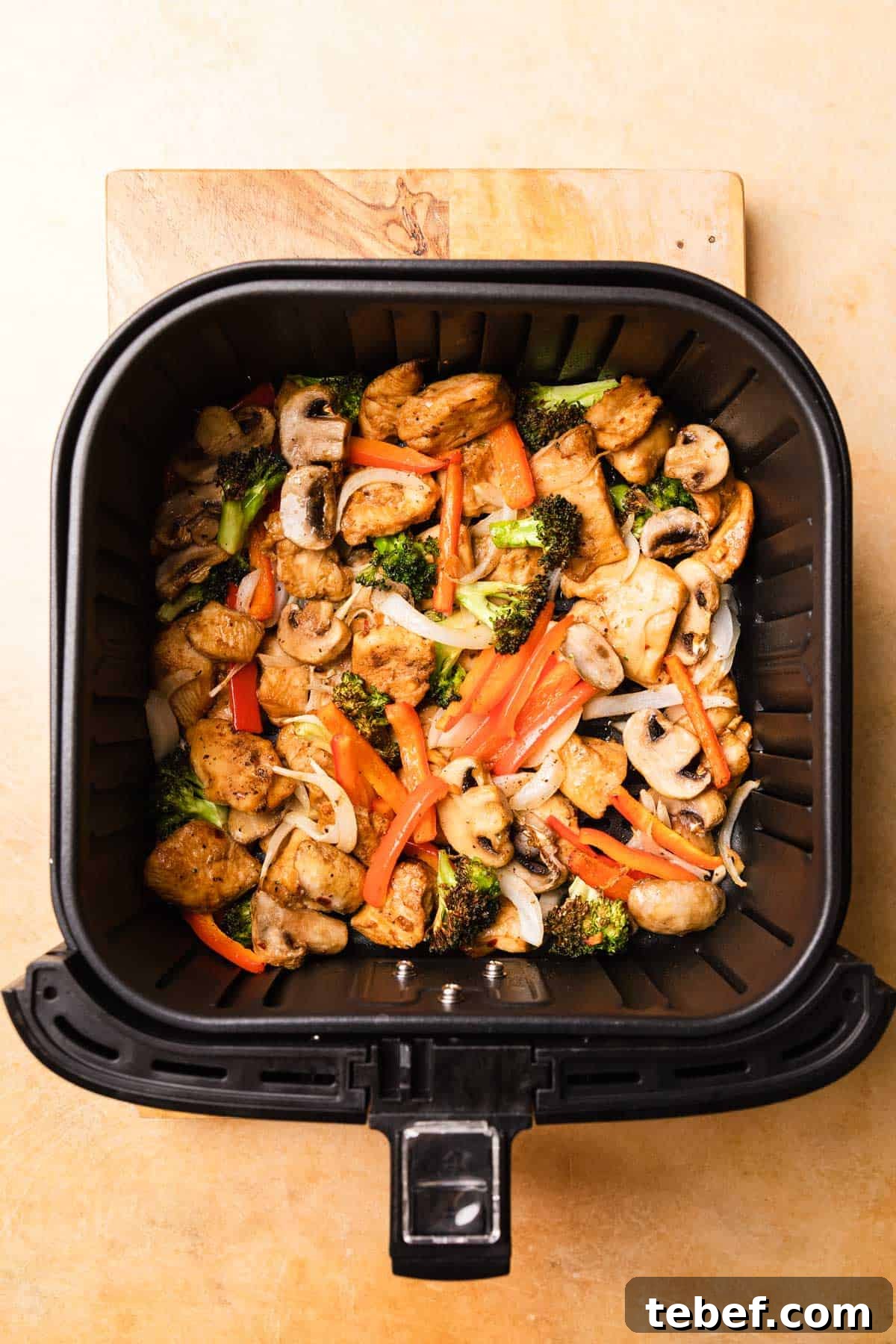 air fryer basket filled with the recipe ingredients after cooking