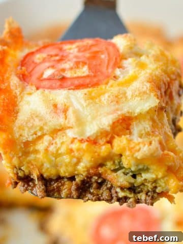 Lifting a square of casserole from a baking dish.