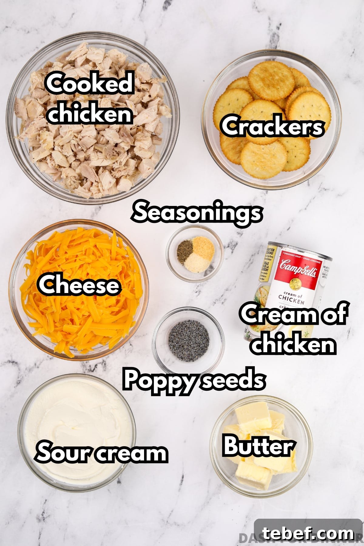 The ingredients needed to make poppy seed chicken. Includes cooked chicken, cheese, sour cream, crackers, butter, and poppy seeds.
