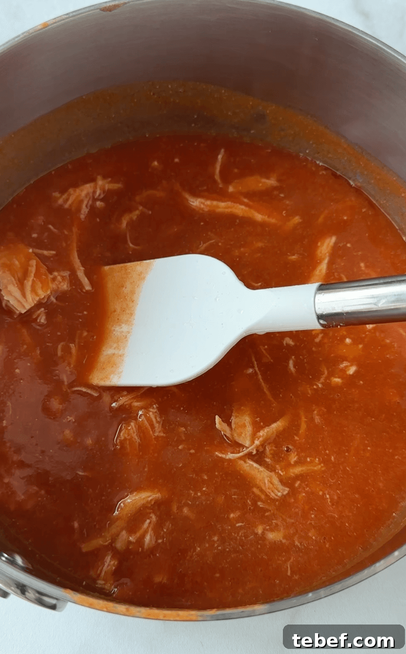 Pot with buffalo chicken mixture being stirred