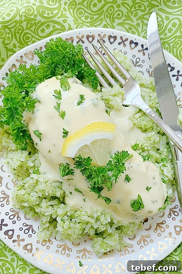 lemon chicken on a plate with broccoli rice and creamy sauce