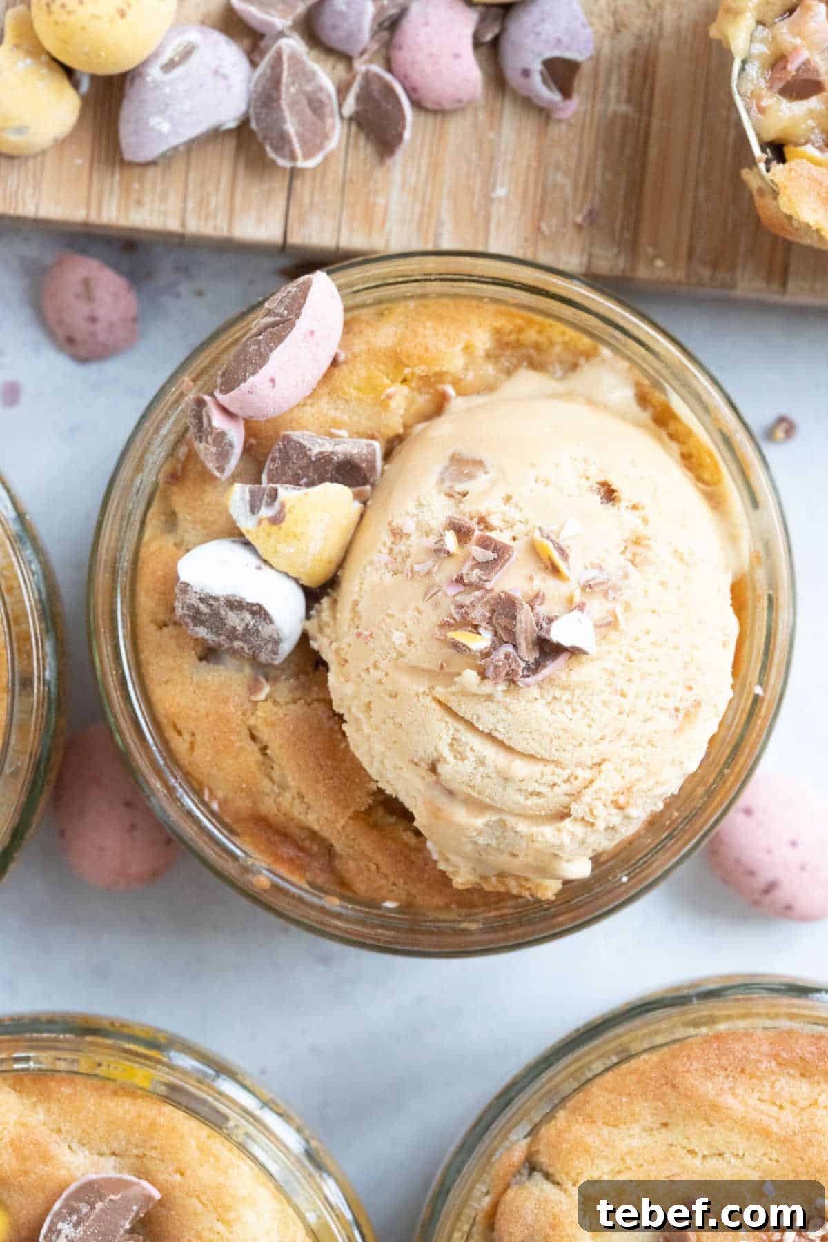Mini egg cookie dough dessert pot with a scoop of ice cream on top.