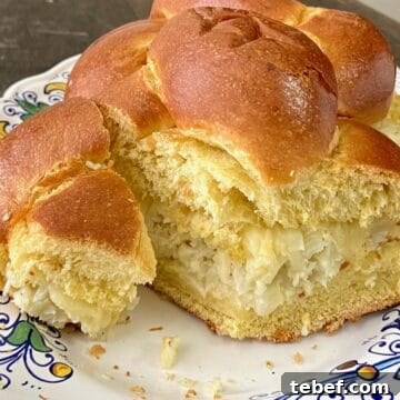 Challah bread loaf stuffed with roasted cauliflower spread and sliced.