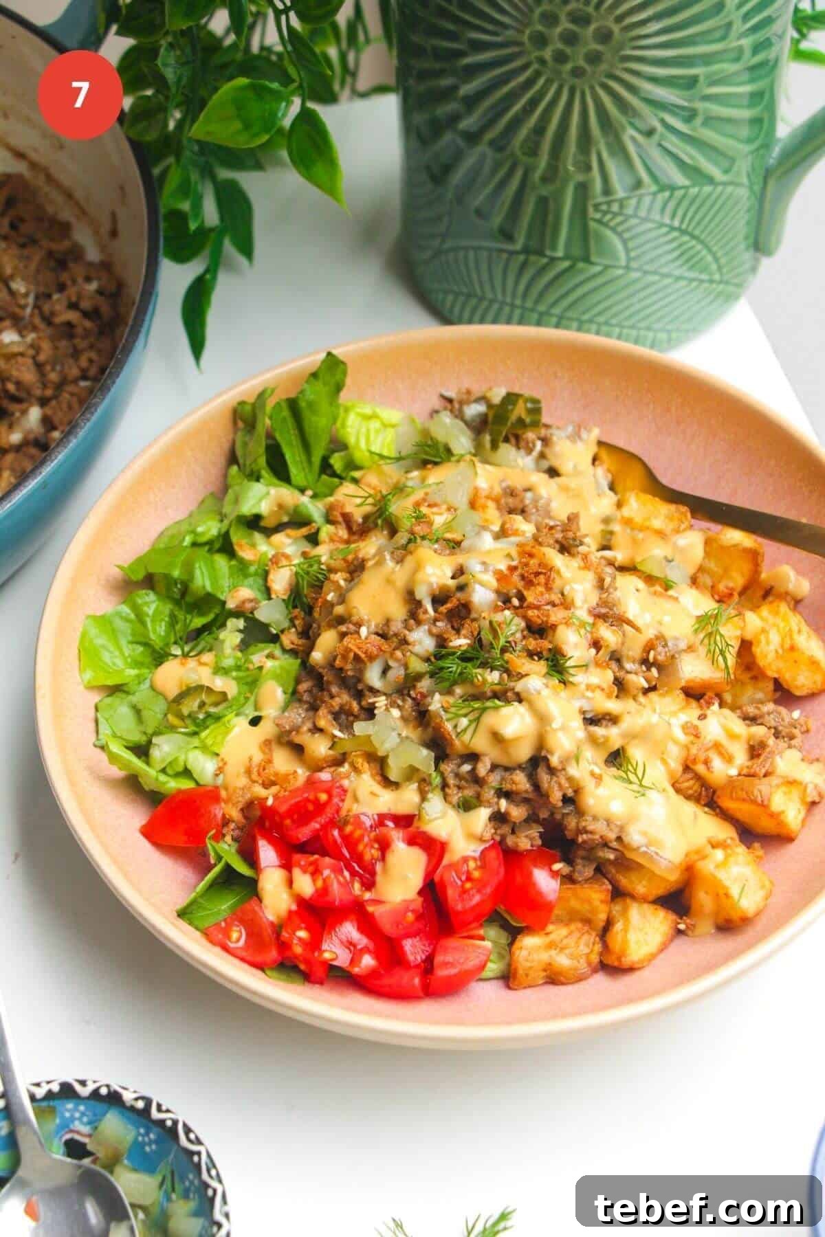 Loaded cheeseburger bowls drizzled with burger sauce.