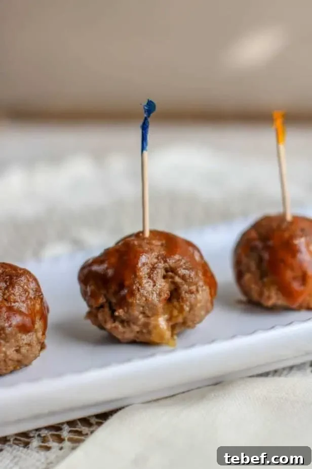 three meatballs with toothpicks