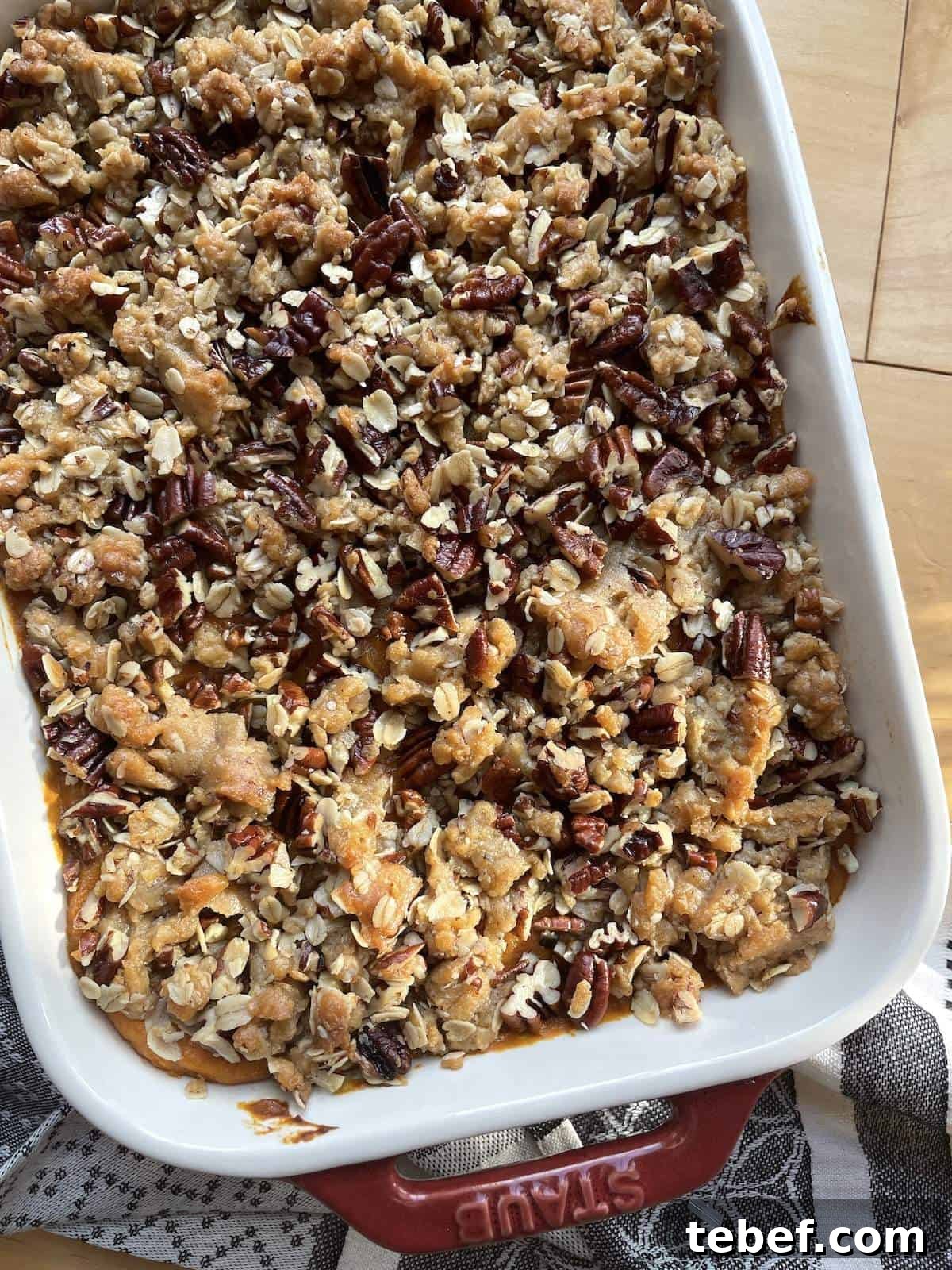 A pan of sweet potato casserole with pecan praline topping.