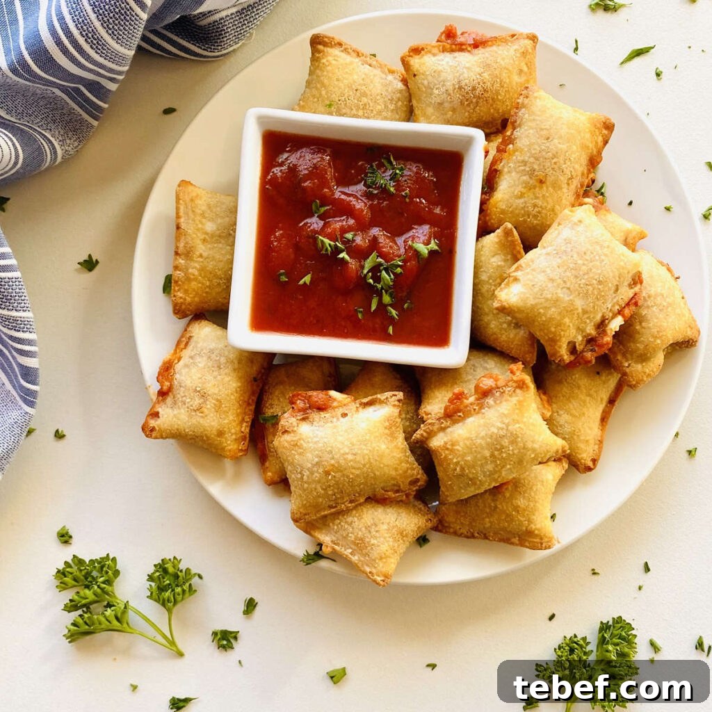 Air fryer pizza rolls on plate next to dish of marinara dipping sauce