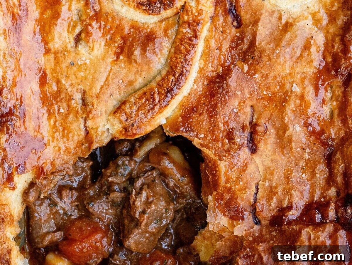 close up on the crust of a beef pie with puff pastry topping