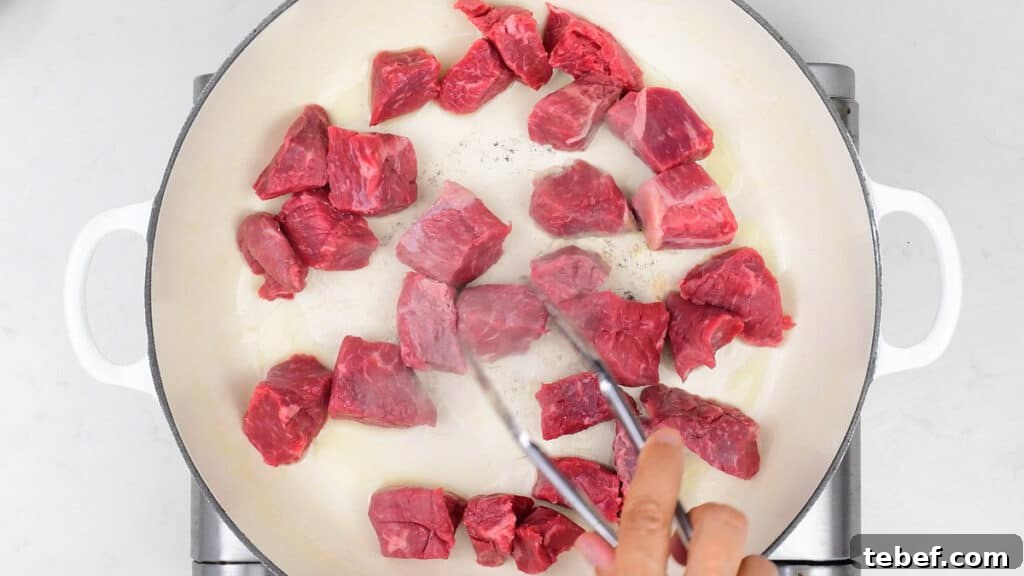 Browning beef cubes in a skillet
