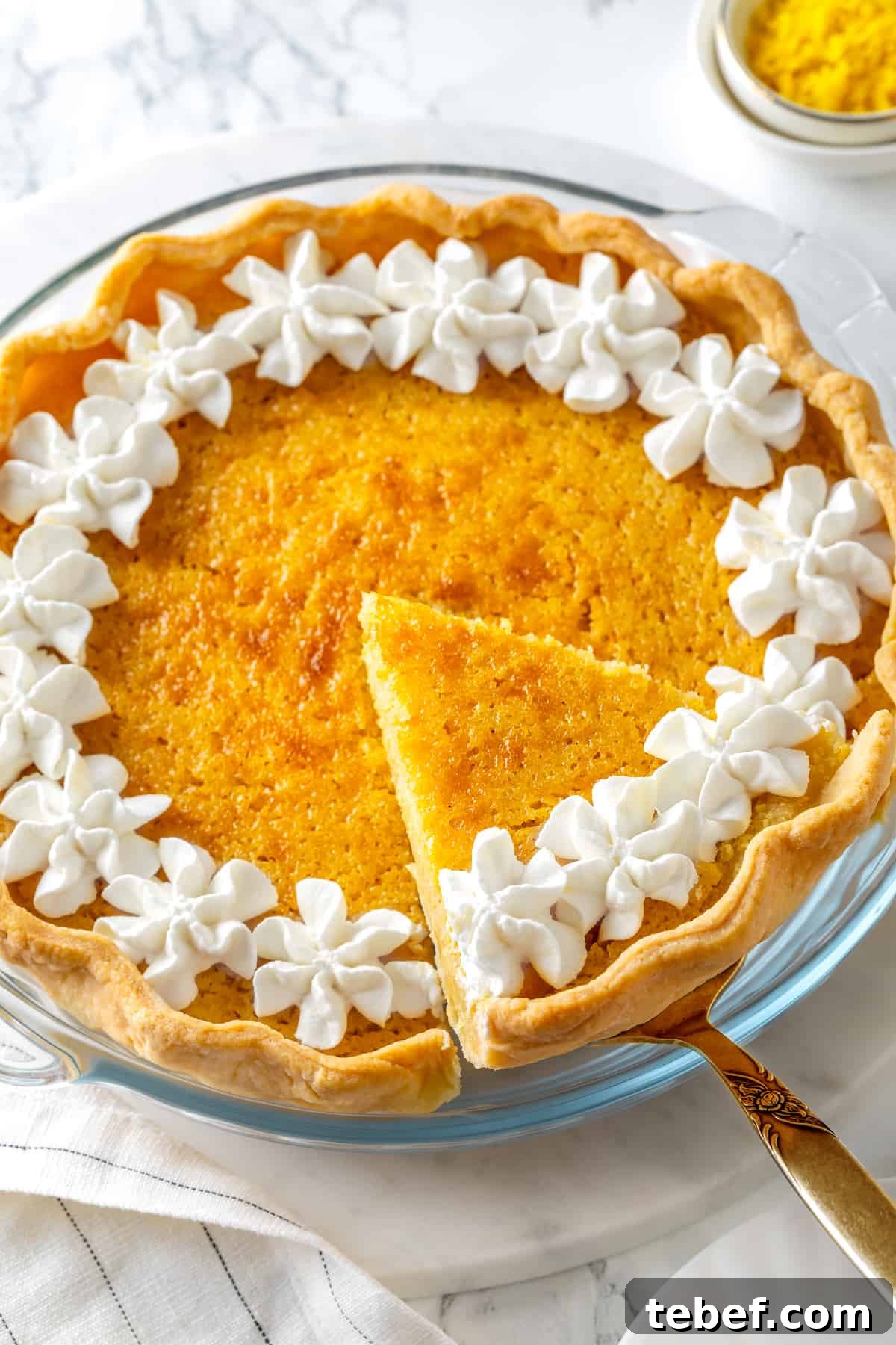 Lifting slice of buttermilk pie from pan