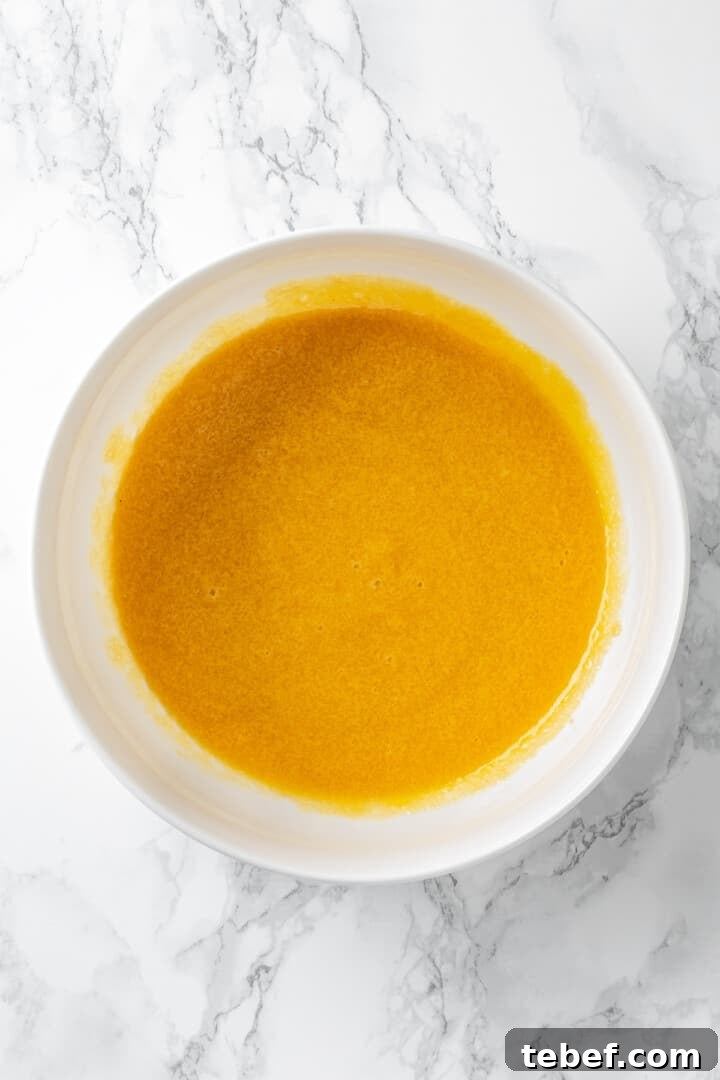 Overhead view of vegan egg and sugar mixture in bowl