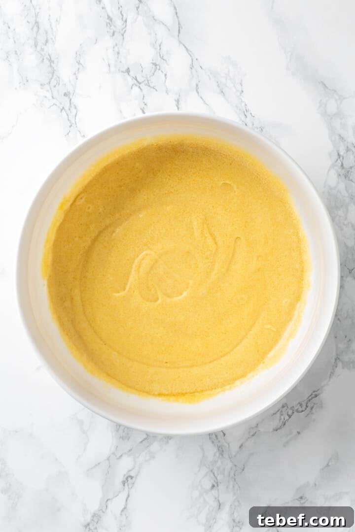 Overhead view of vegan butter, sugar, and egg mixture in mixing bowl