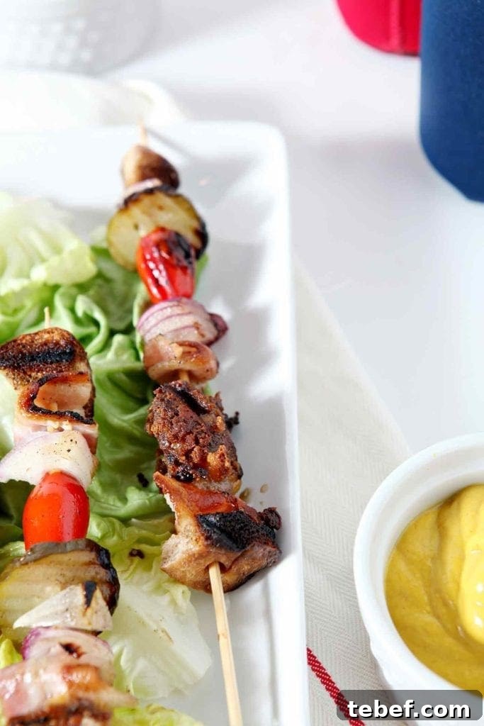 A deconstructed burger on a stick, before eating