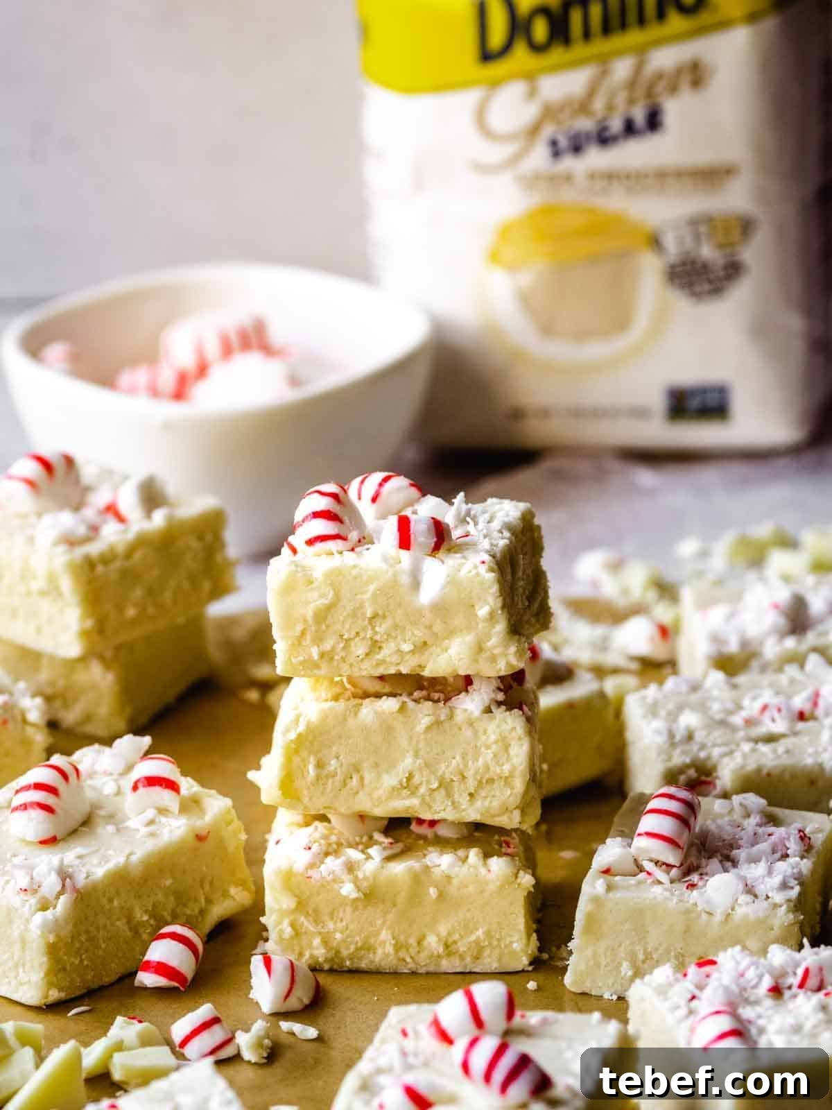 stack of white chocolate peppermint fudge with domino sugar closer up